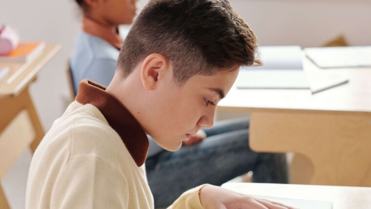 Une enseignante accompagnant un élève de troisième dans la préparation de la rédaction du brevet